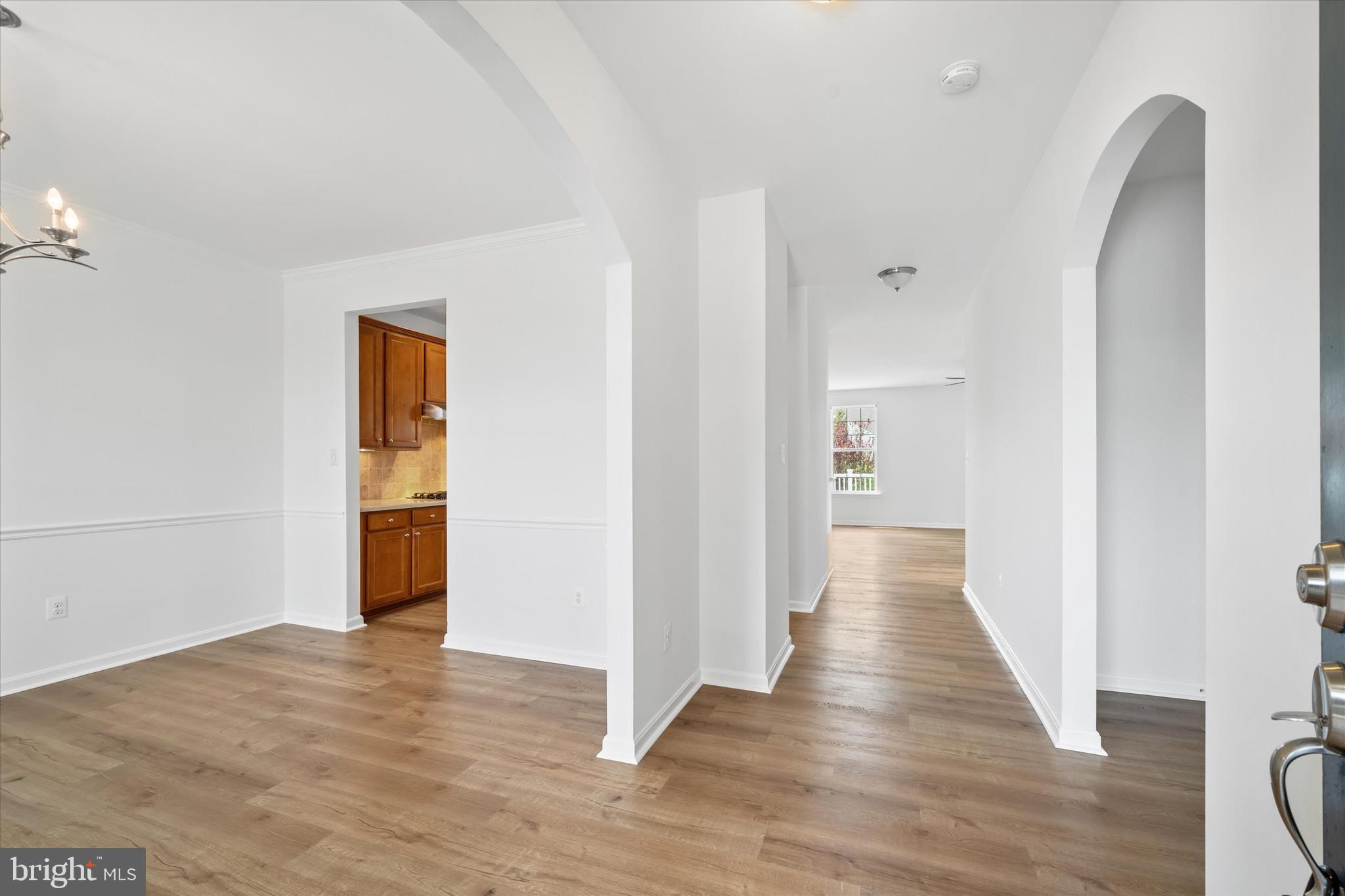 424 Winterberry Drive Middletown, DE 19709 - Photo 5 of 43 a view of a hallway with wooden floor