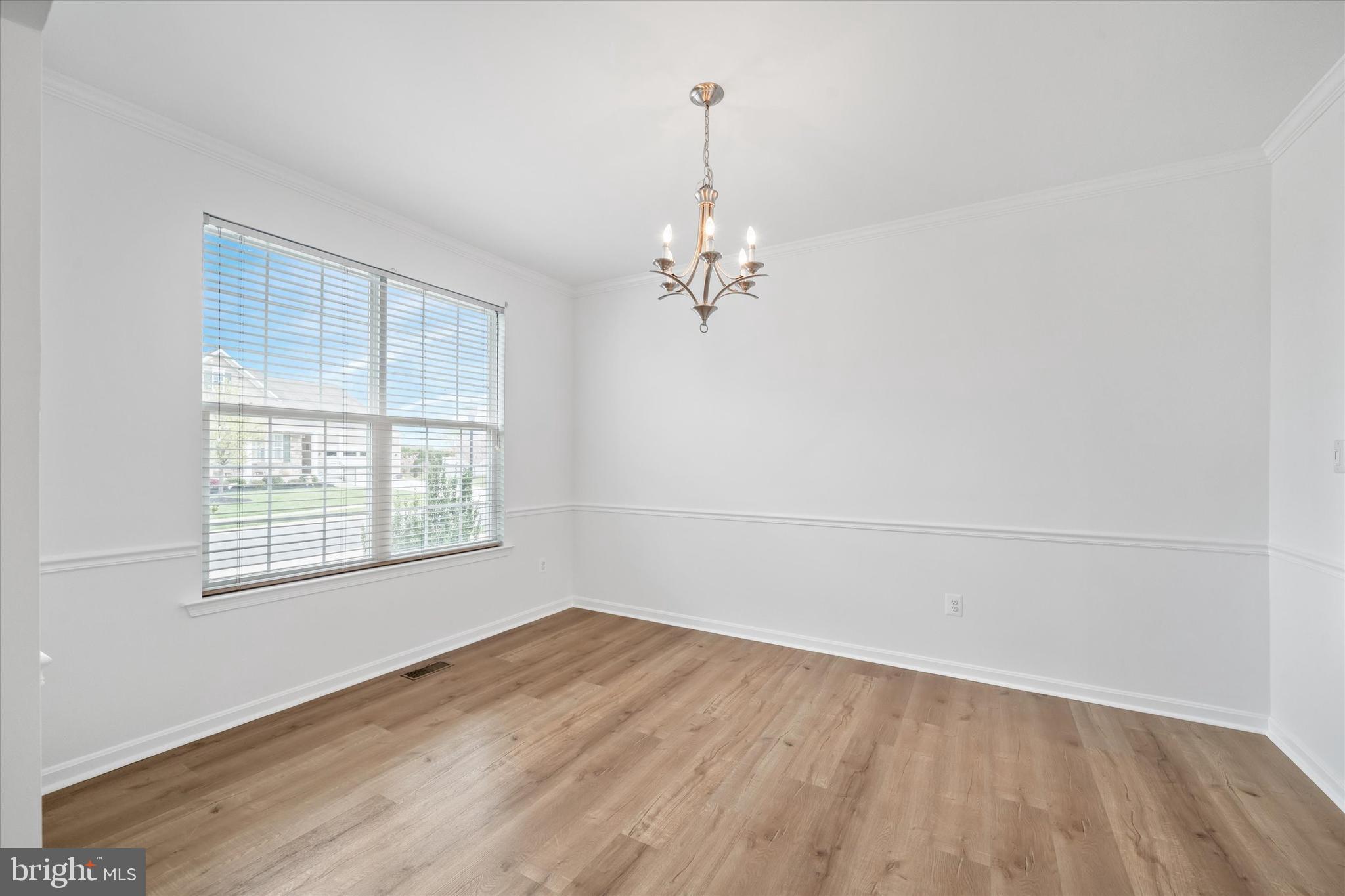 424 Winterberry Drive Middletown, DE 19709 - Photo 7 of 43 an empty room with wooden floor and windows