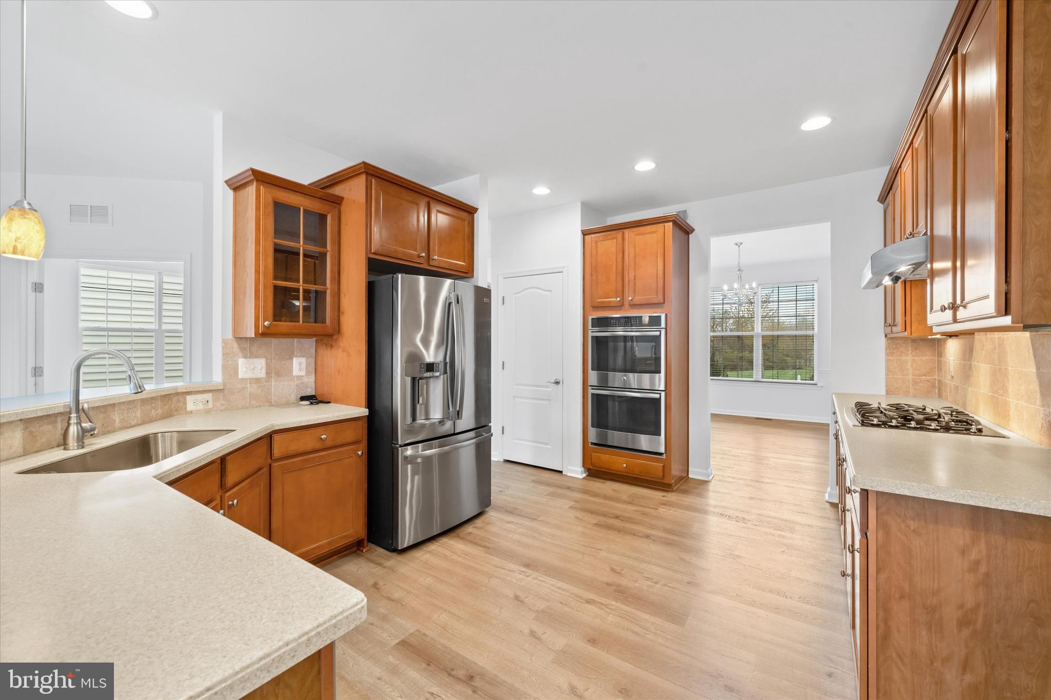 424 Winterberry Drive Middletown, DE 19709 - Photo 9 of 43 a kitchen with stainless steel appliances granite countertop a refrigerator and a sink