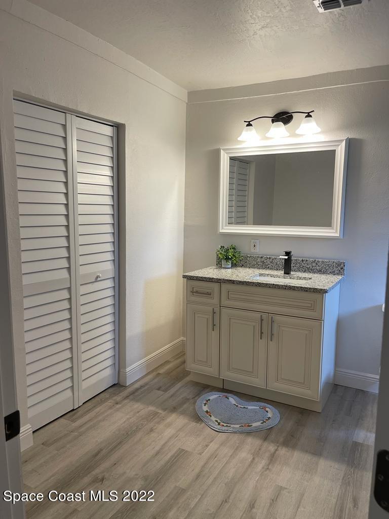 2262 Monroe Street Palm Bay, FL 32905 - Photo 13 of 15 a bathroom with a sink and a mirror