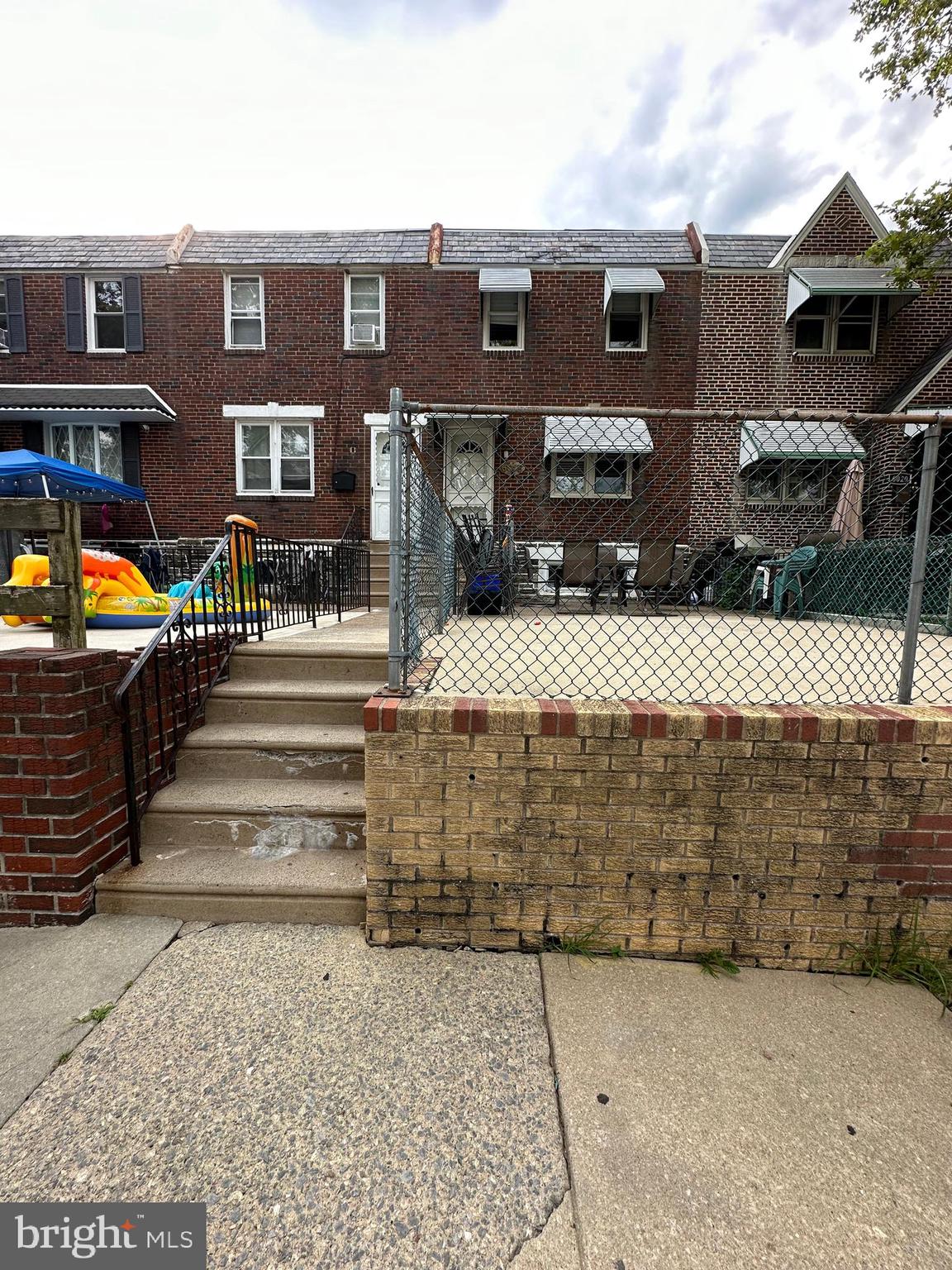 a front view of a house with parking area