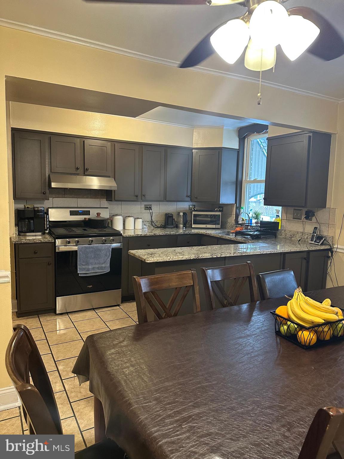 6018 Frontenac Street Philadelphia, PA 19149 - Photo 11 of 30 a kitchen with stainless steel appliances granite countertop a stove a sink and a refrigerator