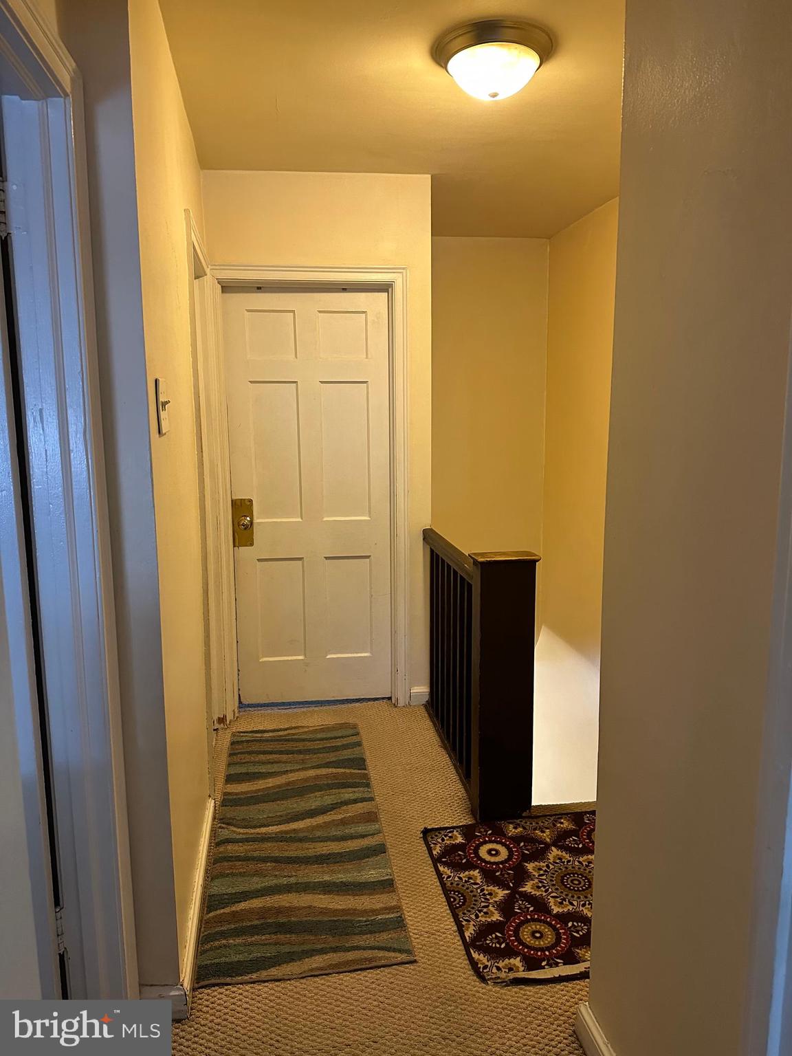 6018 Frontenac Street Philadelphia, PA 19149 - Photo 16 of 30 a view of a hallway with wooden floor and a bathroom