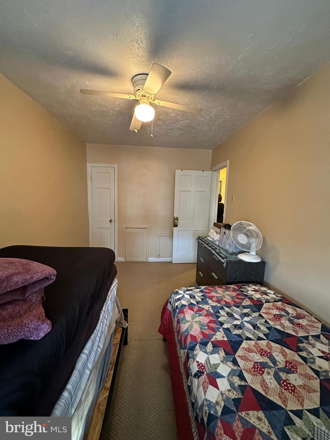 6018 Frontenac Street Philadelphia, PA 19149 - Photo 20 of 30 a bedroom with a bed and a chandelier