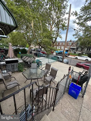 a view of a patio with couches table and chairs and potted plants