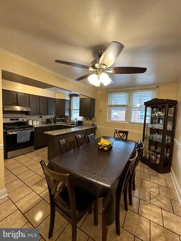 a kitchen with a table chairs and a refrigerator