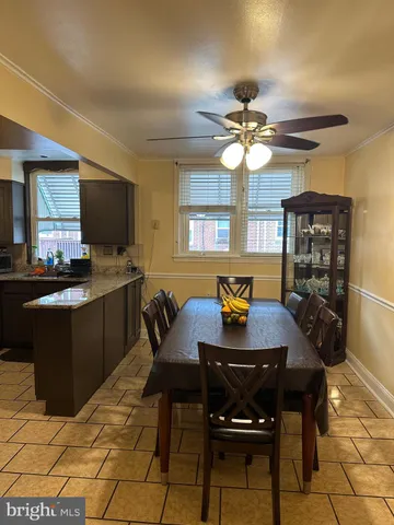 a kitchen with a dining table cabinets and appliances