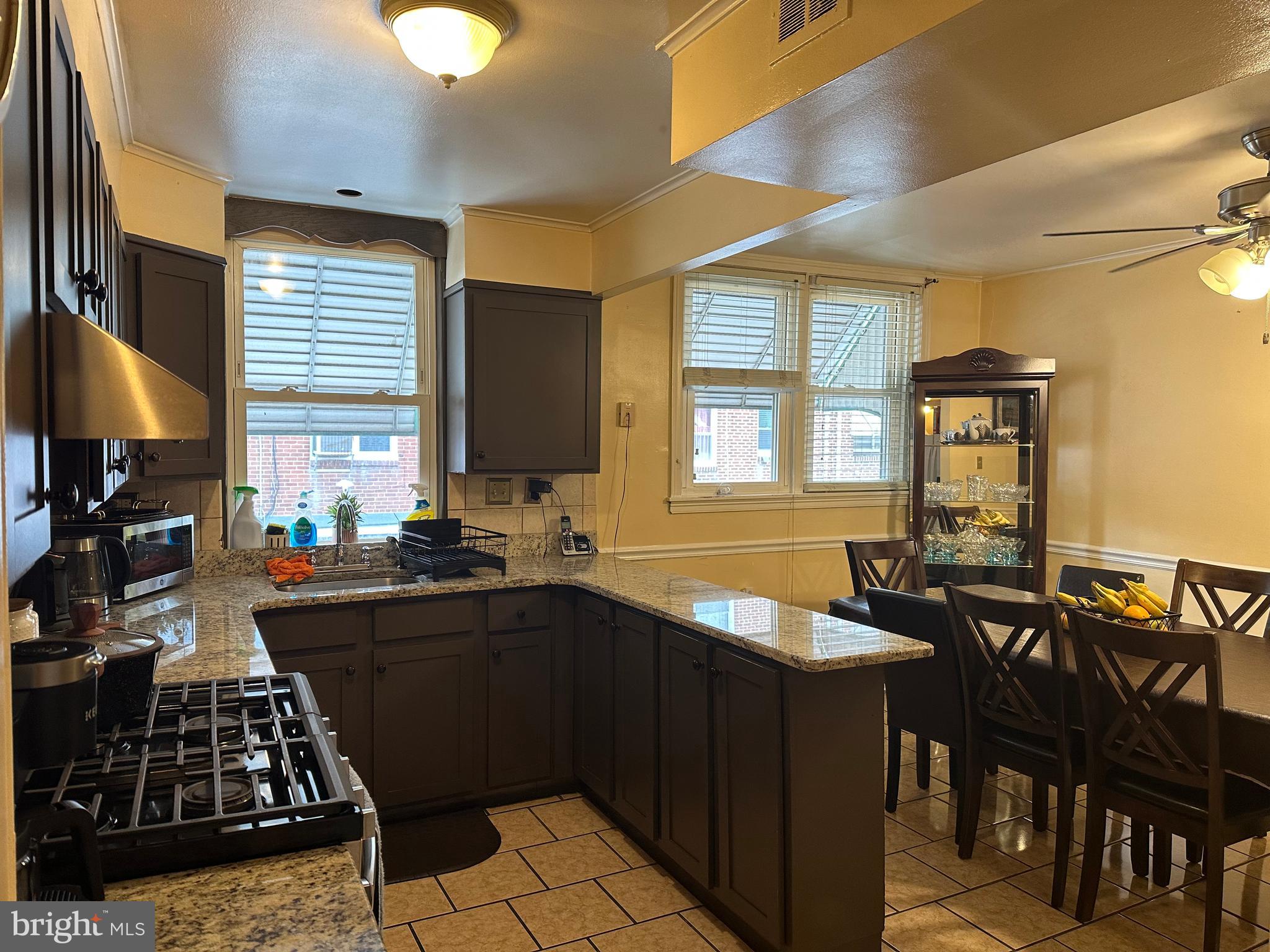 6018 Frontenac Street Philadelphia, PA 19149 - Photo 8 of 30 a kitchen with a table chairs stove and cabinets