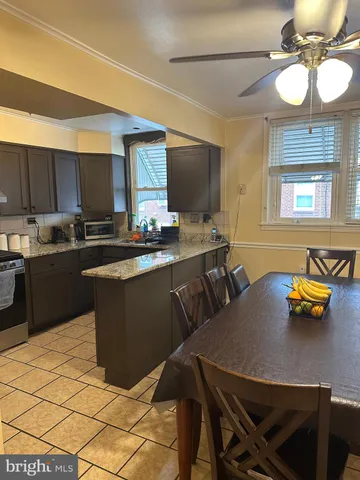 a kitchen with a table chairs and microwave