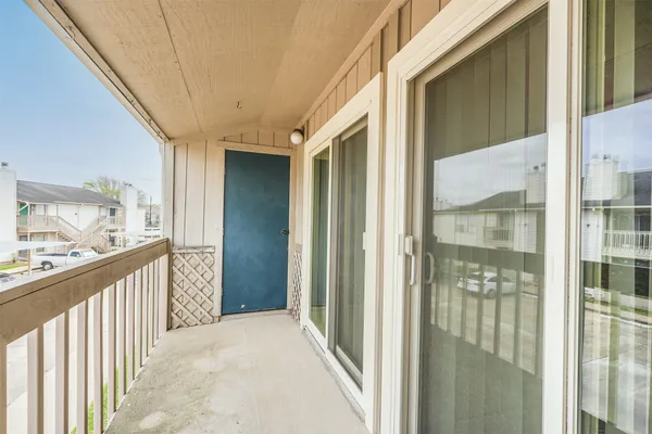 a view of a city from a glass door