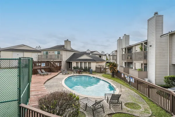 swimming pool view with a seating space
