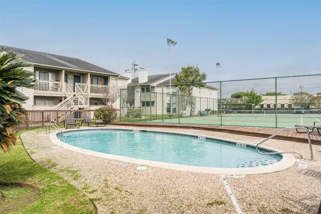 a view of a swimming pool with a yard