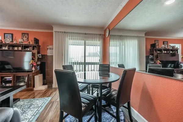 a dining room with furniture and wooden floor