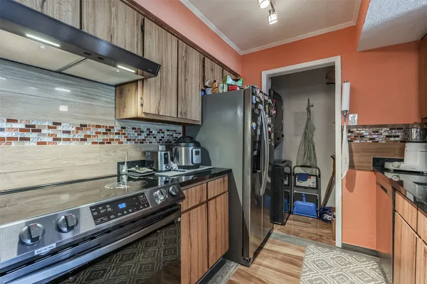 a kitchen with stainless steel appliances granite countertop a stove and a refrigerator