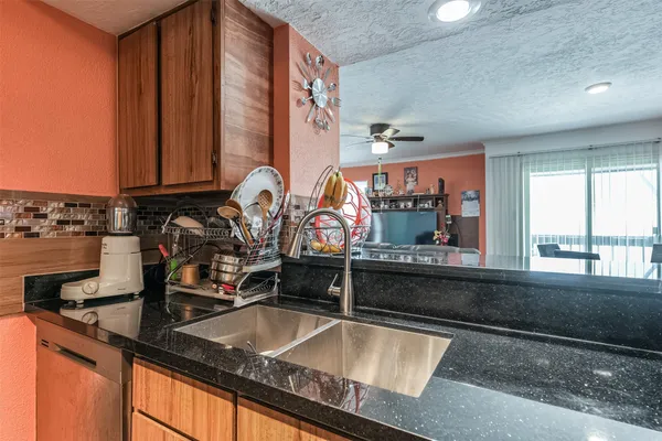 a kitchen with a sink and a wooden cabinets