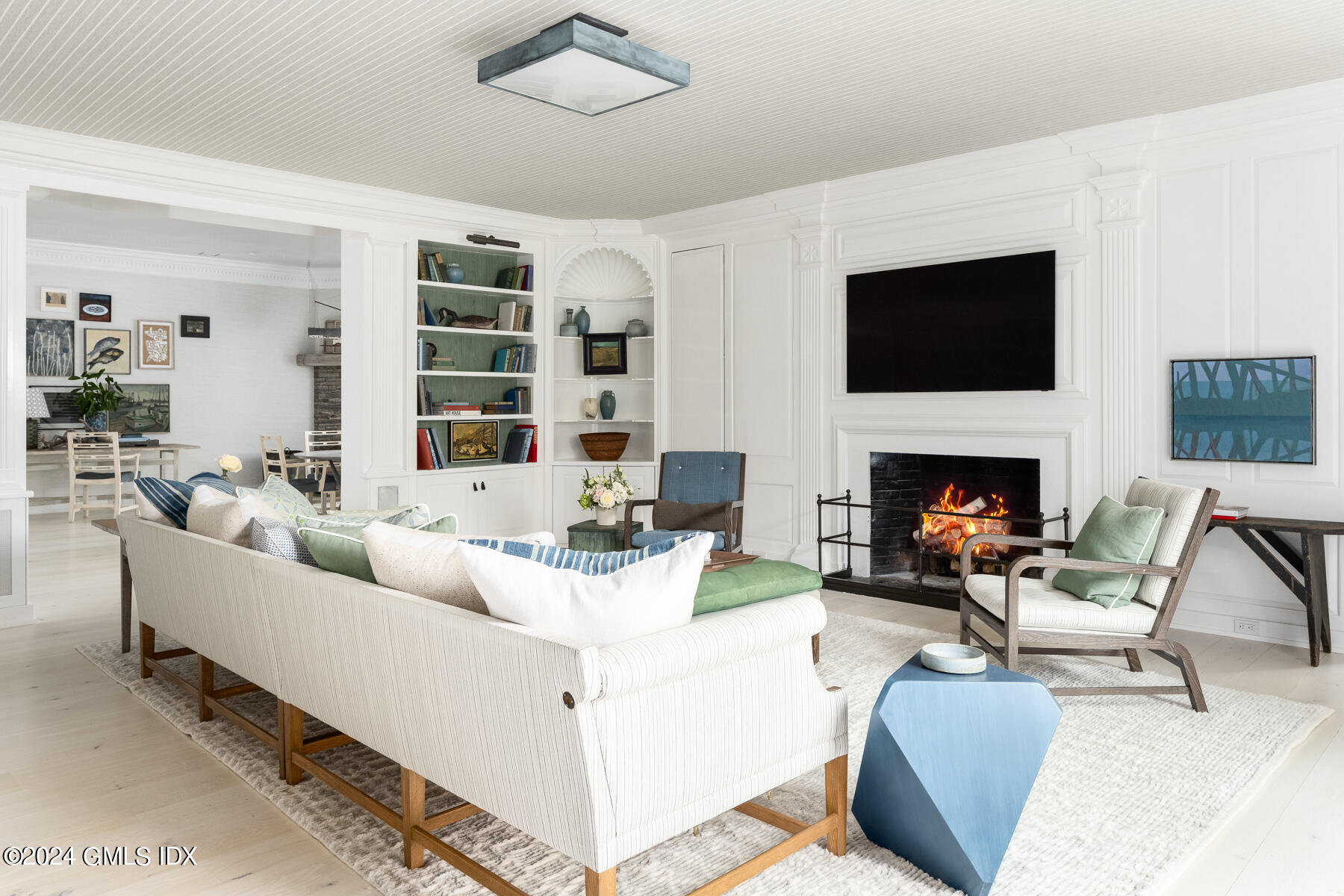 313 Stanwich Road Greenwich, CT 06830 - Photo 12 of 42 a living room with furniture fireplace and a flat screen tv