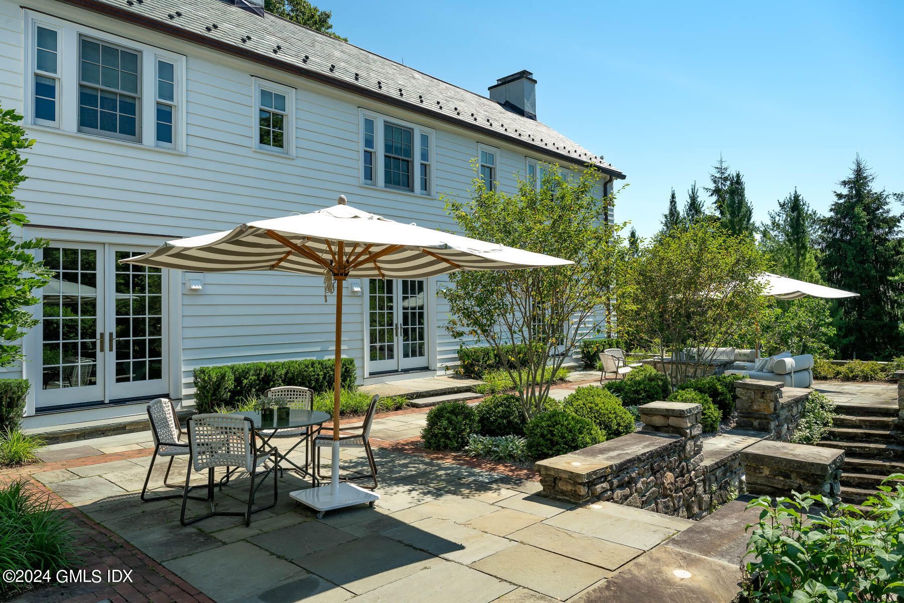 313 Stanwich Road Greenwich, CT 06830 - Photo 30 of 42 a view of a chair and table in backyard of the house