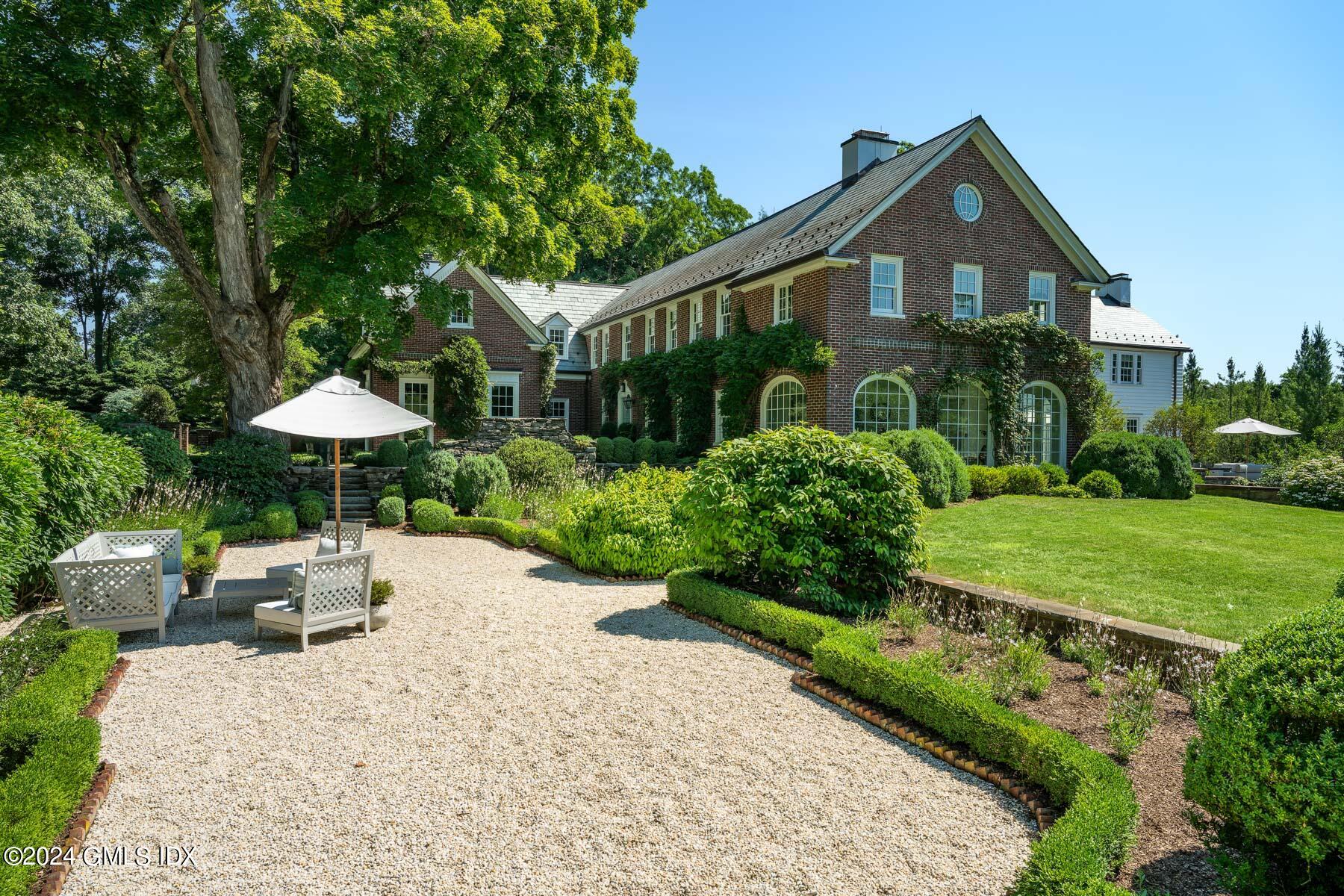 313 Stanwich Road Greenwich, CT 06830 - Photo 40 of 42 a front view of a house with a yard