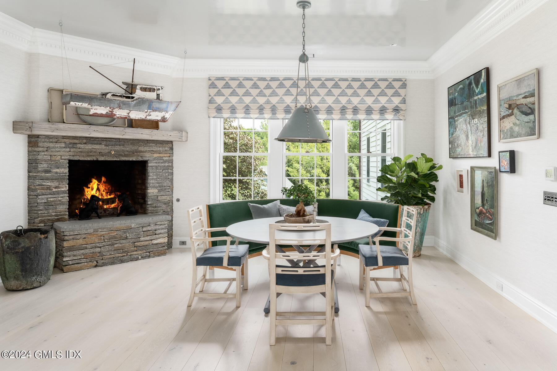 313 Stanwich Road Greenwich, CT 06830 - Photo 10 of 42 a dining room with furniture a fireplace and wooden floor