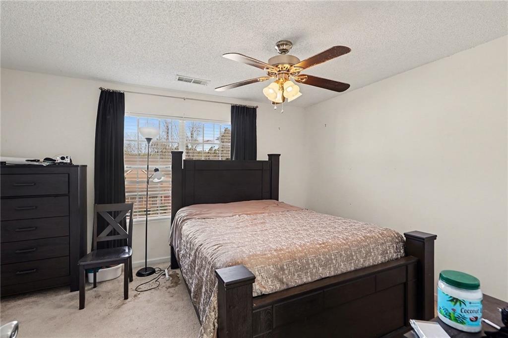 123 Chastain Circle Newnan, GA 30263 - Photo 17 of 27 a bedroom with a bed and a chandelier