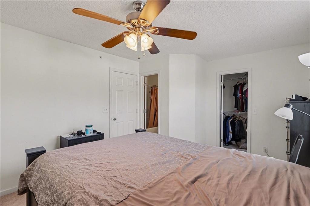 123 Chastain Circle Newnan, GA 30263 - Photo 19 of 27 a bedroom with a bed and a chandelier