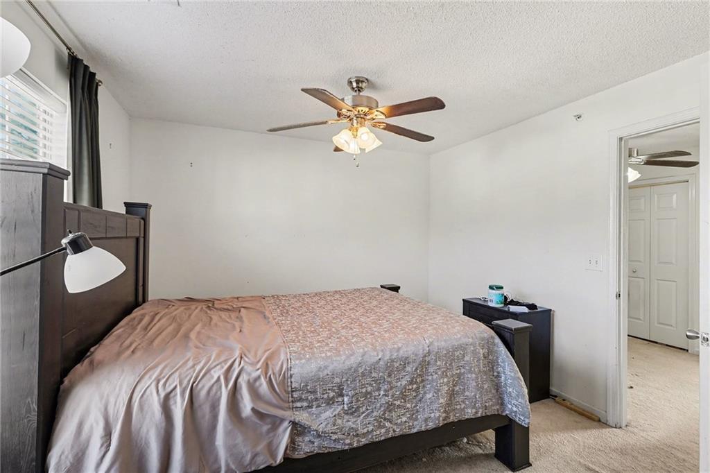 123 Chastain Circle Newnan, GA 30263 - Photo 20 of 27 a bedroom with a bed and a chandelier