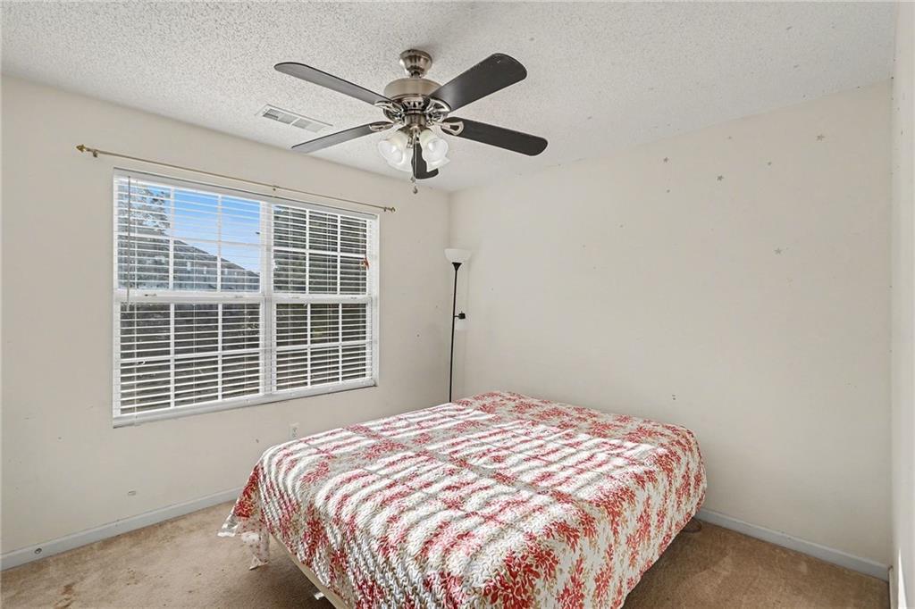 123 Chastain Circle Newnan, GA 30263 - Photo 21 of 27 a bedroom with a bed and a window