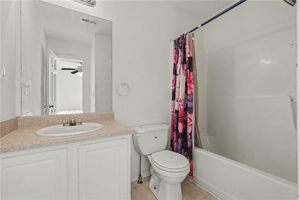 123 Chastain Circle Newnan, GA 30263 - Photo 23 of 27 a bathroom with a sink a toilet and shower curtain