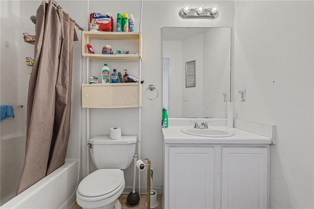 123 Chastain Circle Newnan, GA 30263 - Photo 24 of 27 a bathroom with a sink a toilet and a mirror