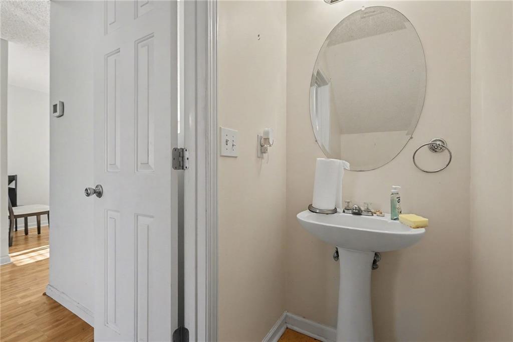 123 Chastain Circle Newnan, GA 30263 - Photo 25 of 27 a bathroom with a sink a mirror and shower
