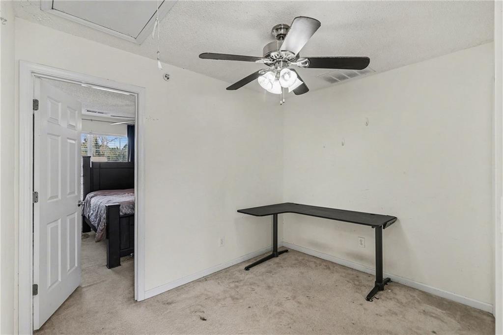 123 Chastain Circle Newnan, GA 30263 - Photo 26 of 27 a view of a hallway with a livingroom and a bathroom