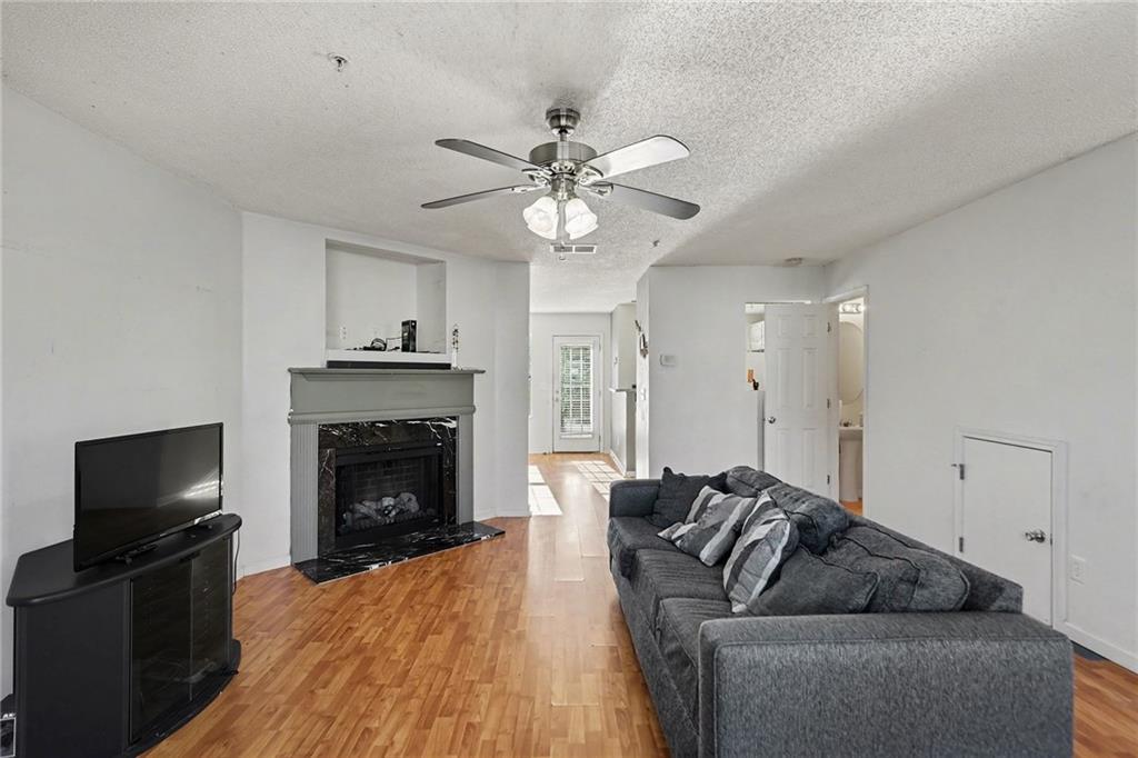 123 Chastain Circle Newnan, GA 30263 - Photo 4 of 27 a living room with furniture a flat screen tv and a fireplace
