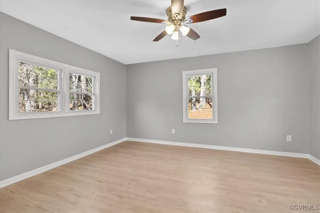 a view of room with window and ceiling fan