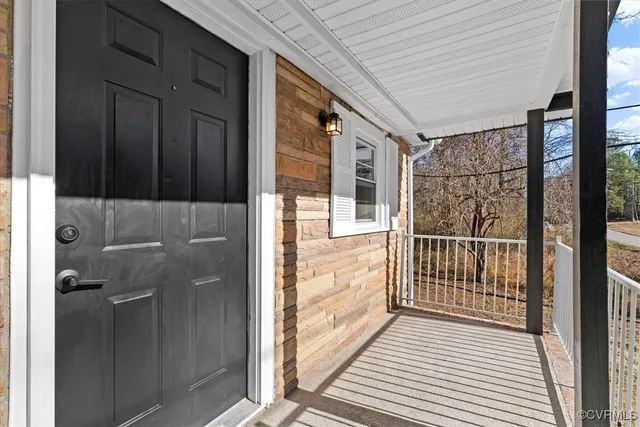 a view of a porch with wooden floor
