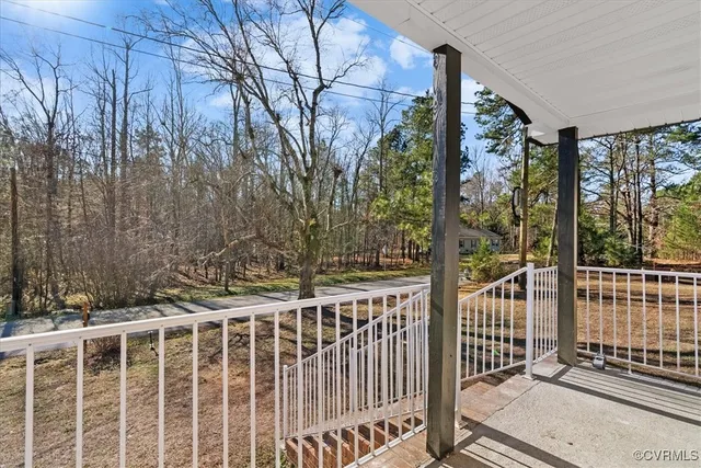 a view of a house with a small yard and wooden fence