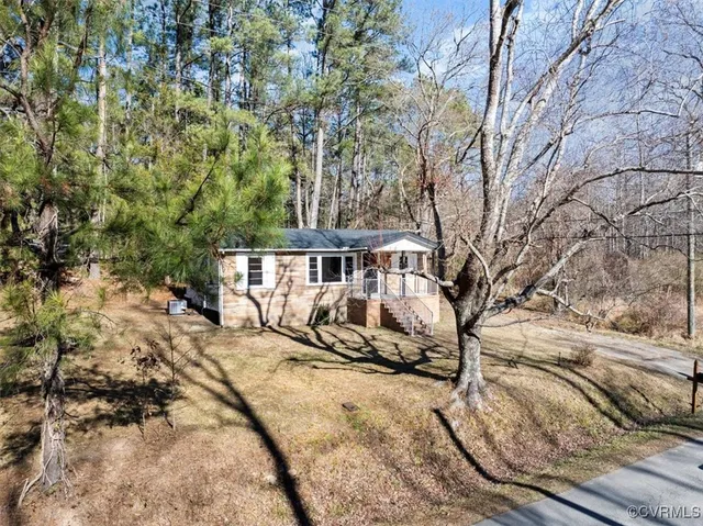 a view of a yard with wooden fence