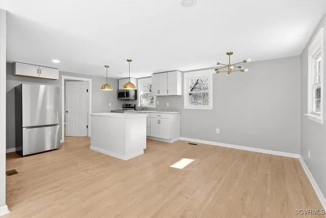 a view of a kitchen with a sink and refrigerator