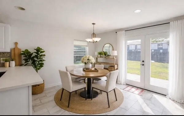 a view of a dining room with furniture window and wooden floor