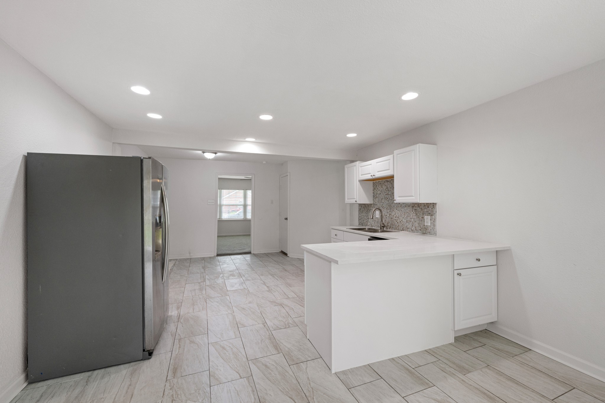 1426 Shawnee Street Houston, TX 77034 - Photo 12 of 28 The view from your open concept kitchen area. This breakfast bar is perfect for the little ones or entertaining.