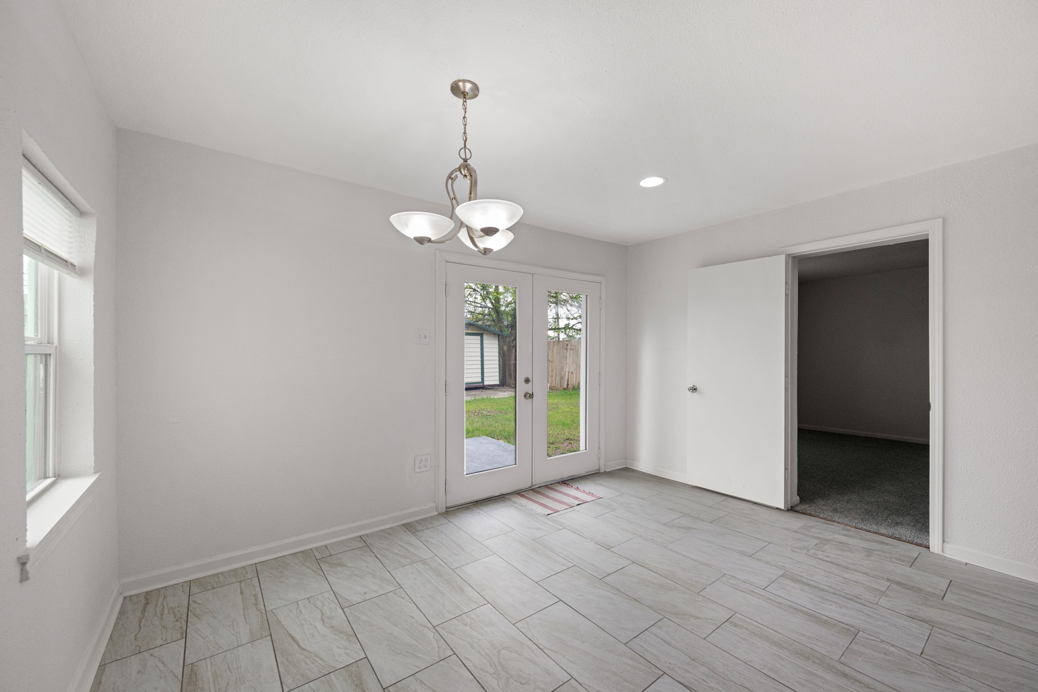 1426 Shawnee Street Houston, TX 77034 - Photo 19 of 34 This bright dining area features modern title flooring, neutral color palette that complements any style. French doors give you easy access to your backyard.