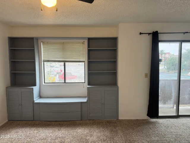 a view of room with window and ceiling fan
