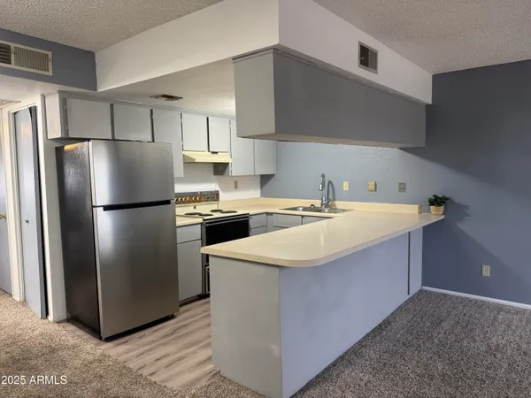 a kitchen with a sink a refrigerator and a stove