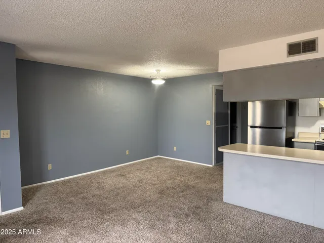 a kitchen with stainless steel appliances a refrigerator and a stove