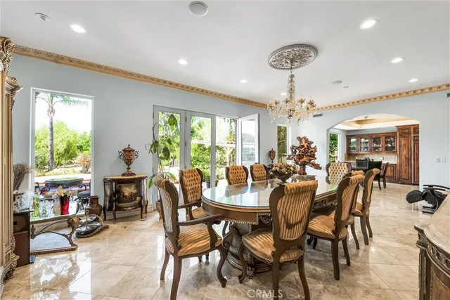 a view of a dining room with furniture a chandelier and wooden floor