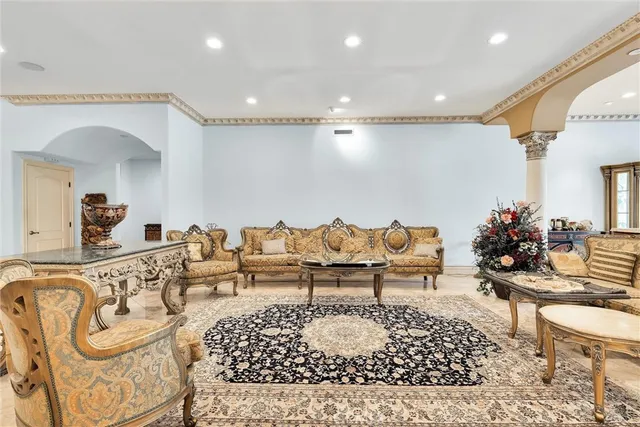 a dining room with furniture a chandelier and wooden floor