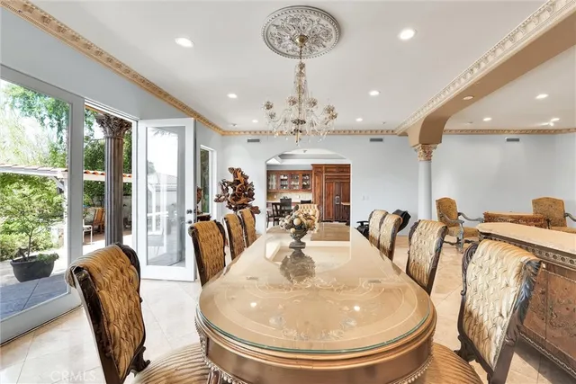 a living room with fireplace furniture and a dining table with fireplace