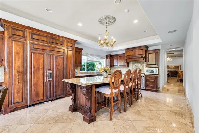 a living room with furniture a chandelier and a dining table