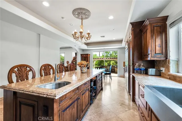 a dining room with furniture a chandelier and wooden floor