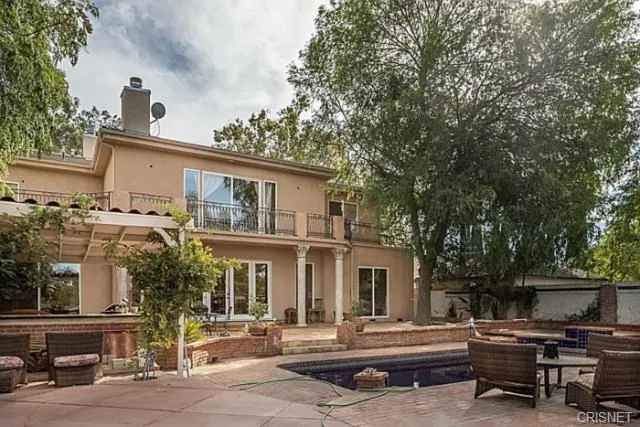 a backyard of a house with outdoor seating