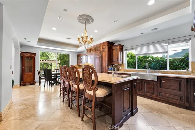 a living room with fireplace furniture and a dining table with fireplace